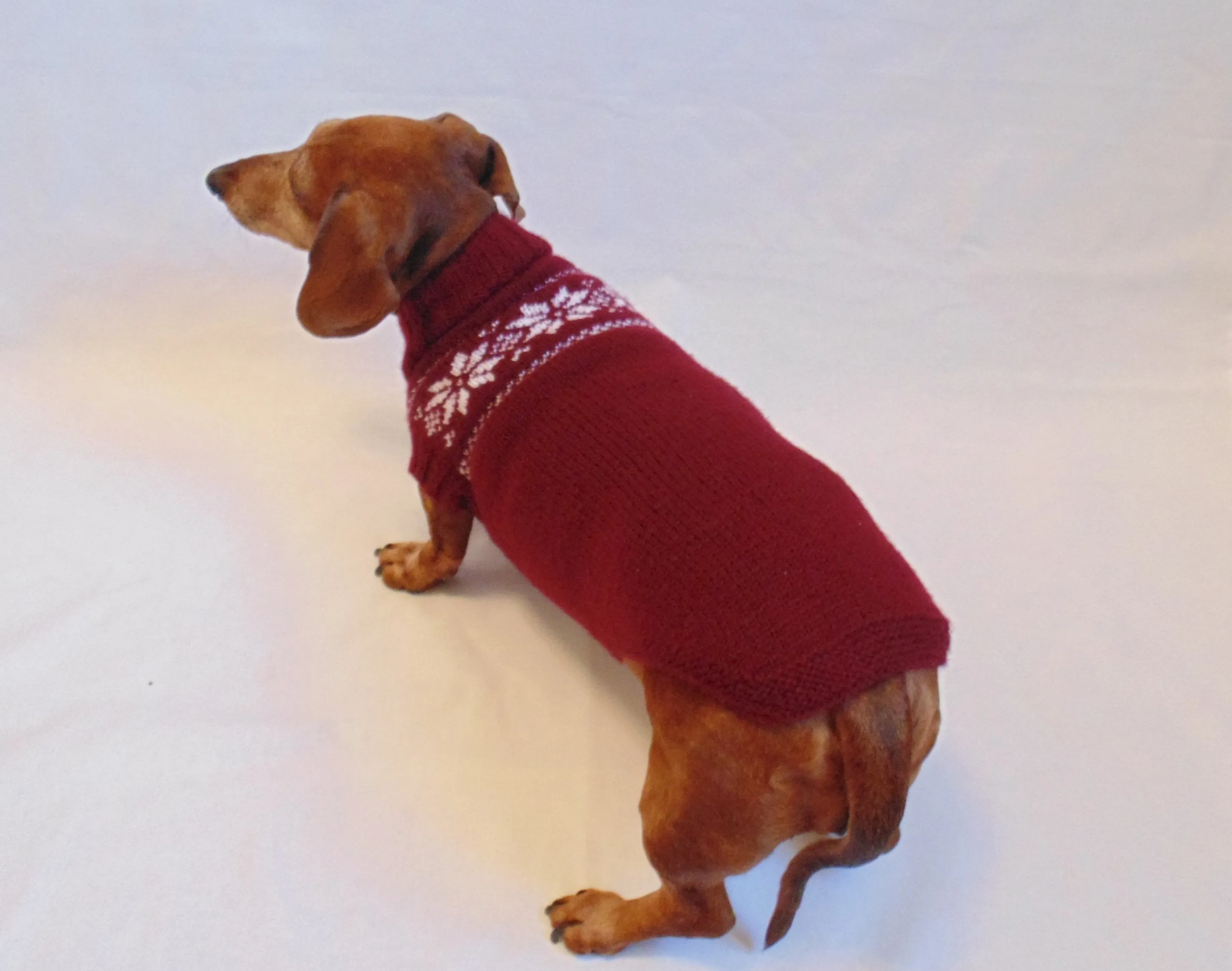 Christmas knitted sweater with snowflakes for a dog, clothes for dachshund